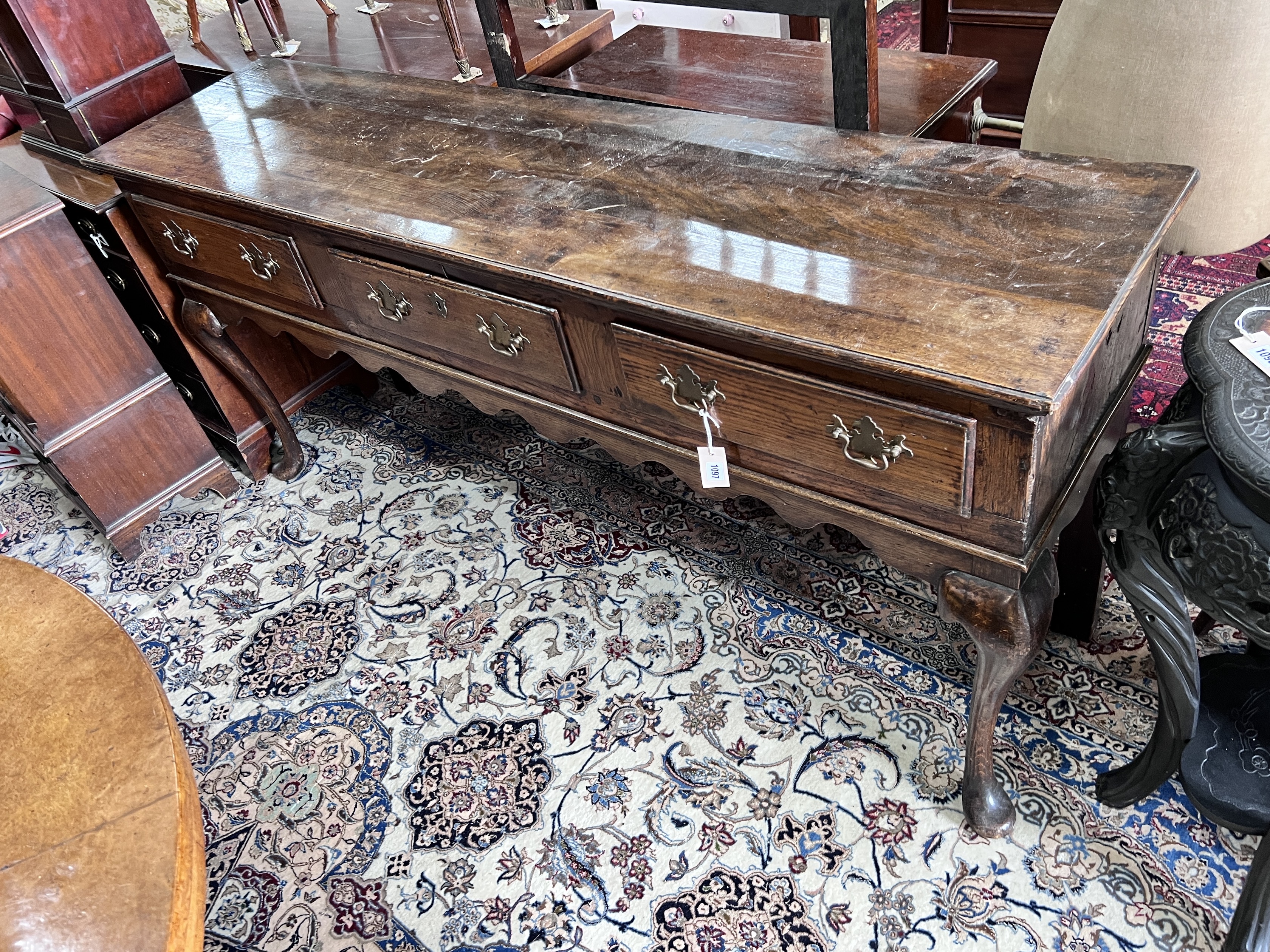 An 18th century and later oak low dresser on cabriole supports, width 178cm, depth 45cm, height 83cm